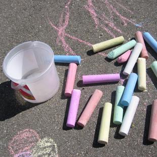 Children and families - sticks of chalk on pavement