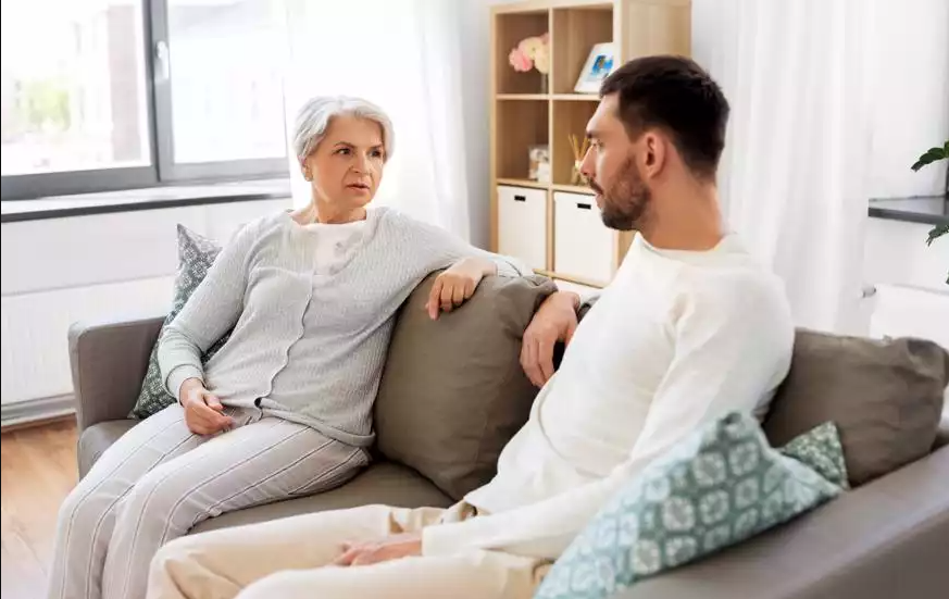 Older woman sitting with younger man